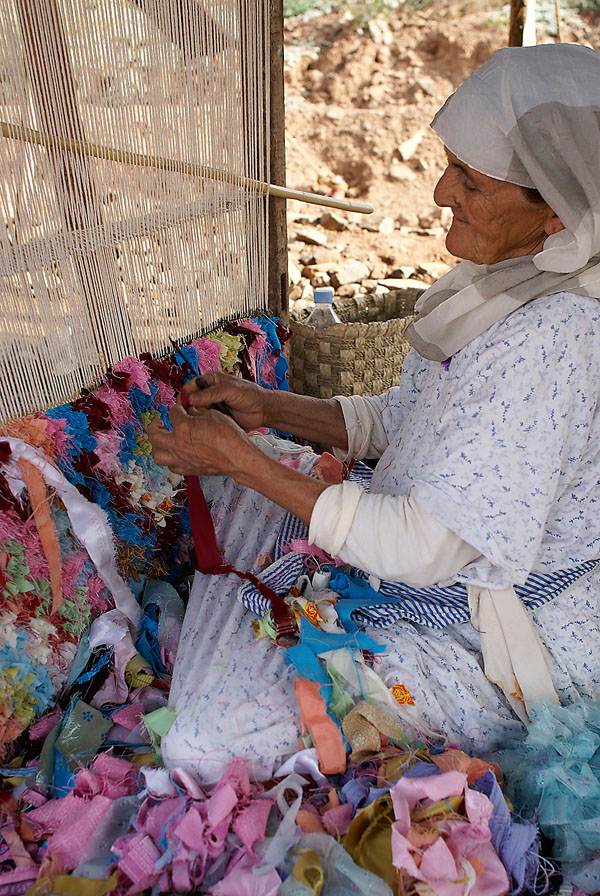 Berber woman making rug